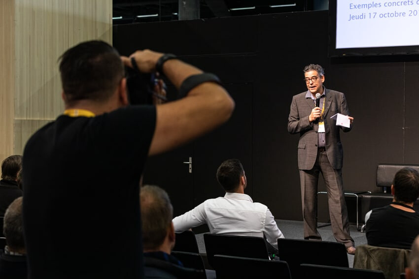 Journalist macht ein Fotos eines Sprechers auf der Bühne an der Holz Messe.